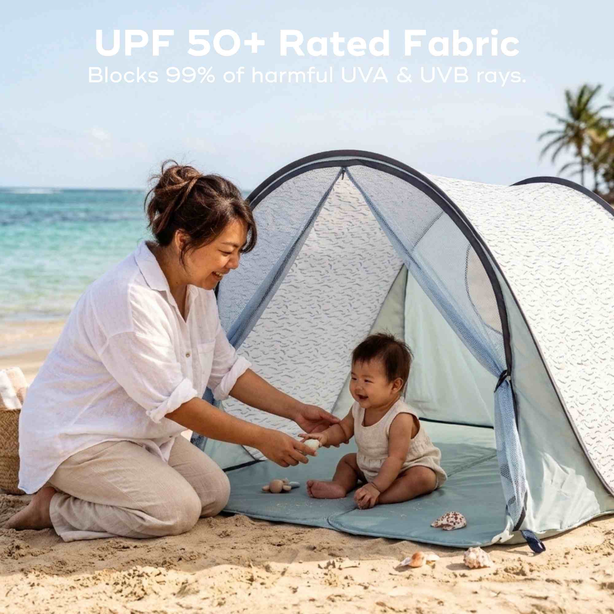 Woman and child playing on a beach with a UPF 50+ rated fabric pop up tent.